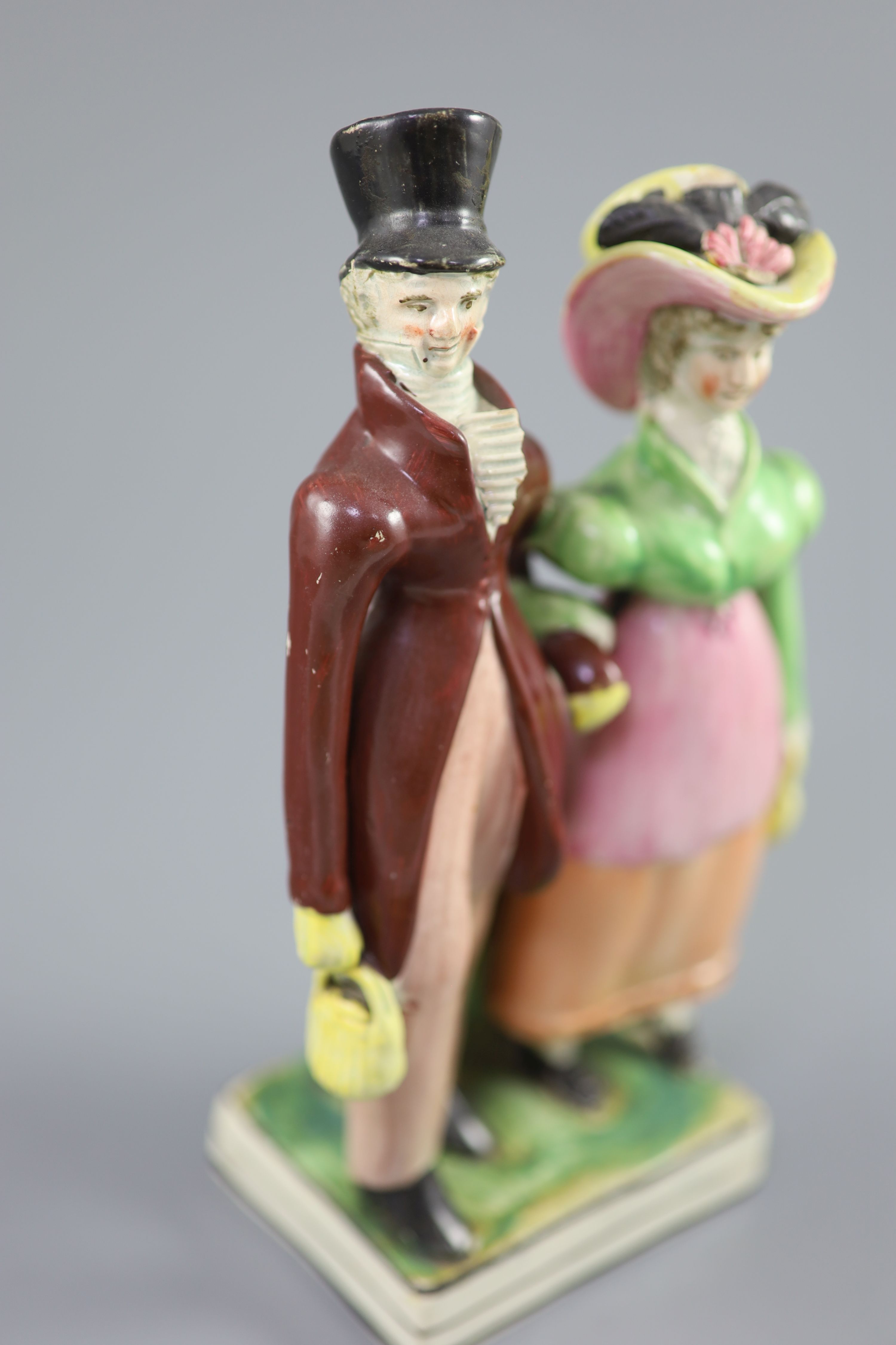 A Staffordshire pearlware group of a Dandy and Dandizette, c.1820, 21cm high